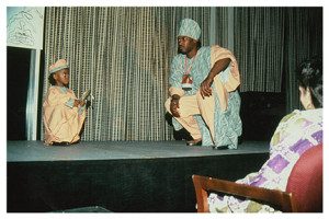 Two men on a stage in traditional dress