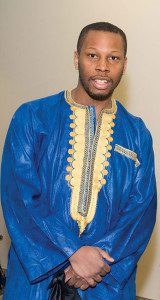 A man in blue and yellow outfit standing up.